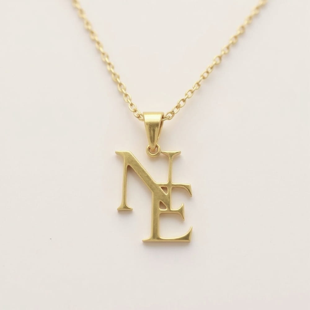 Gold necklace with a pendant on a light gray background